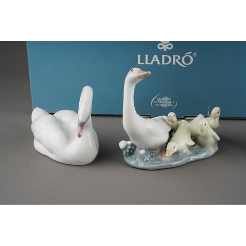 24 - Two boxed Lladro figures and three loose Lladro figures, the boxed figures comprising no.7049 