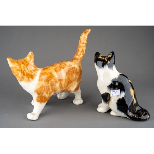 26 - Two Winstanley pottery cats, comprising a ginger and white standing cat, length 26cm x height 23.5cm... 