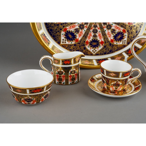 35 - A Royal Crown Derby Imari 1128 pattern miniature five piece tea set and oval tray, the tea set compr... 