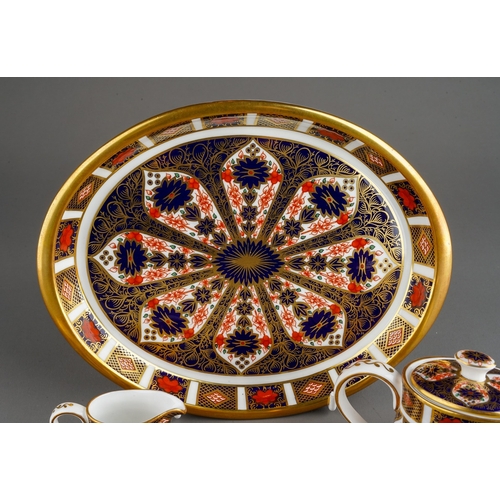 35 - A Royal Crown Derby Imari 1128 pattern miniature five piece tea set and oval tray, the tea set compr... 