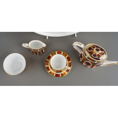 35 - A Royal Crown Derby Imari 1128 pattern miniature five piece tea set and oval tray, the tea set compr... 