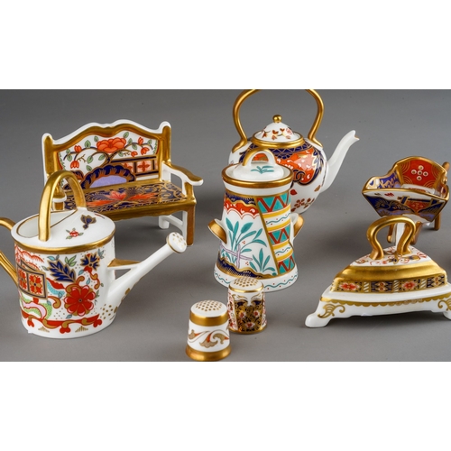 44 - A collection of seven Royal Crown Derby Imari miniatures and two Royal Crown Derby thimbles, the min... 