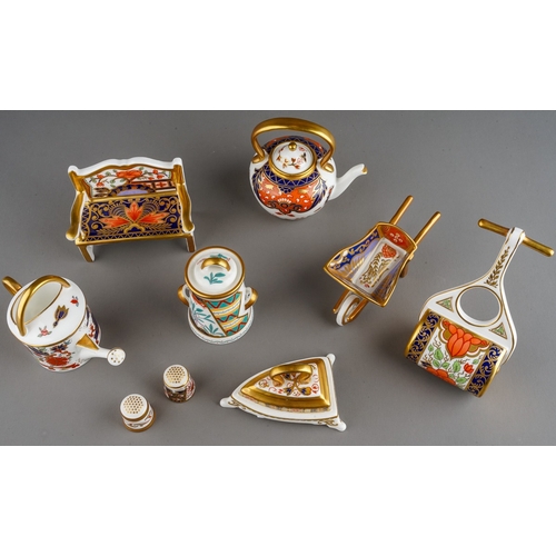 44 - A collection of seven Royal Crown Derby Imari miniatures and two Royal Crown Derby thimbles, the min... 