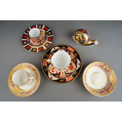 46 - A Derby porcelain coffee can and two matched saucers decorated flowers and gilt scrolls, circa 1840s... 