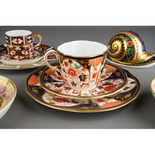 46 - A Derby porcelain coffee can and two matched saucers decorated flowers and gilt scrolls, circa 1840s... 