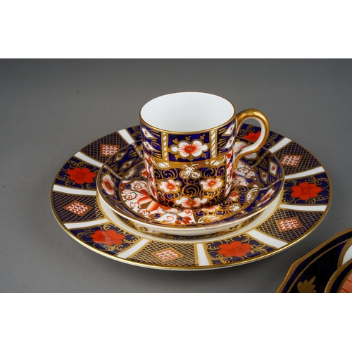 46 - A Derby porcelain coffee can and two matched saucers decorated flowers and gilt scrolls, circa 1840s... 