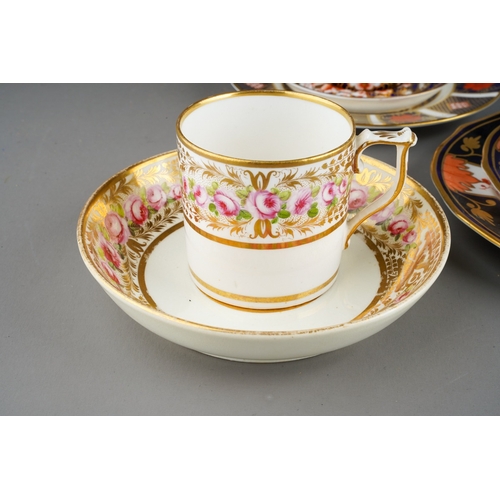 46 - A Derby porcelain coffee can and two matched saucers decorated flowers and gilt scrolls, circa 1840s... 