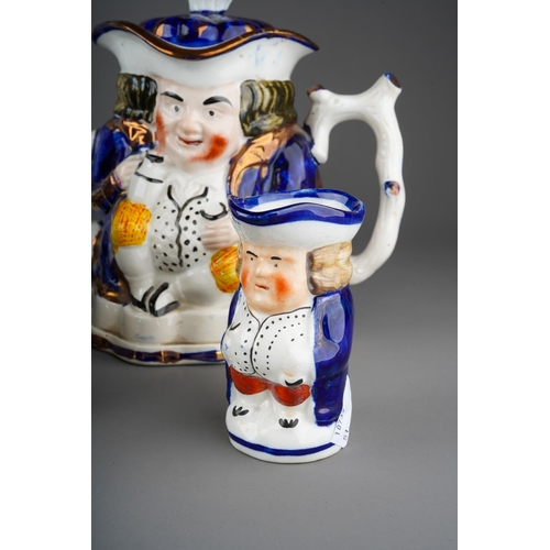 55 - Two large Staffordshire character Toby Jugs with two small character mugs, a novelty pepper pot mode... 