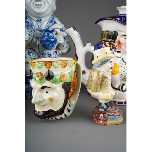 55 - Two large Staffordshire character Toby Jugs with two small character mugs, a novelty pepper pot mode... 