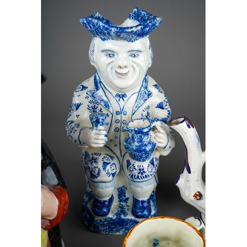 55 - Two large Staffordshire character Toby Jugs with two small character mugs, a novelty pepper pot mode... 