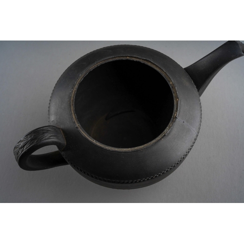 56 - A Regency black basalt large teapot, impressed vine leaf banding above Prince of Wales feather and G... 