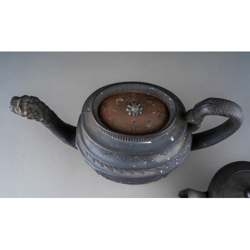 56 - A Regency black basalt large teapot, impressed vine leaf banding above Prince of Wales feather and G... 