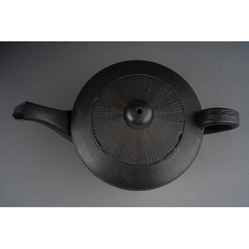 56 - A Regency black basalt large teapot, impressed vine leaf banding above Prince of Wales feather and G... 