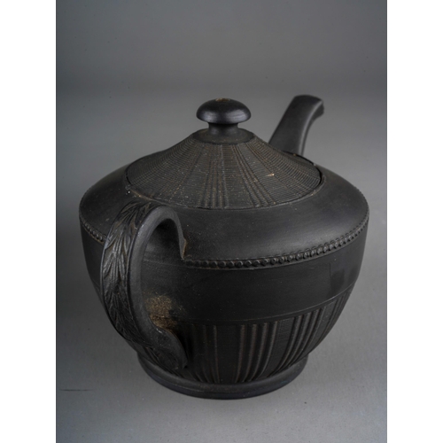 56 - A Regency black basalt large teapot, impressed vine leaf banding above Prince of Wales feather and G... 