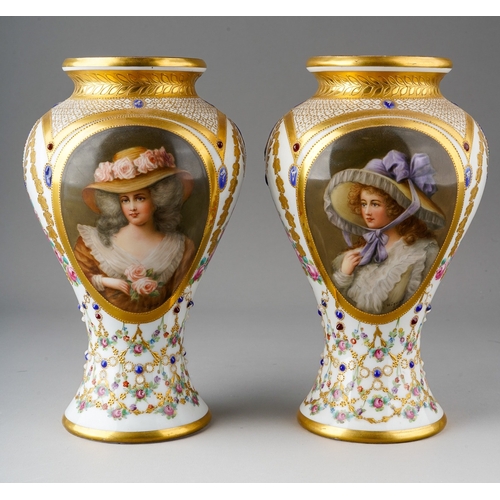 64 - A pair of early 20th Century Vienna porcelain vases, each profusely decorated with gilt and painted ... 