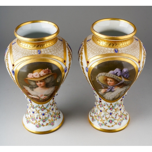 64 - A pair of early 20th Century Vienna porcelain vases, each profusely decorated with gilt and painted ... 