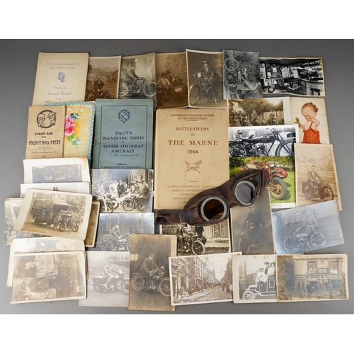 A bag of military and motorbike interest ephemera, including a pair of leather motoring goggles with brown glass lenses, a booklet of Pilots Handling Notes for Auster Autocraft Aircraft, a 1943 pamphlet First Aid for Fighting Men, a 1919 copy of Illustrated Michelin Guides To The Battlefields (Battle-Fields of The Marne 1914), assorted postcards and greetings cards, etc (1 bag)