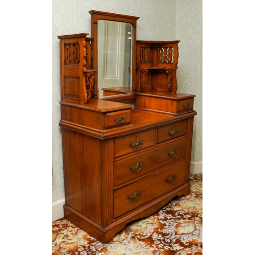 387 - An Edwardian walnut dressing table, the back with central swing mirror flanked by fret carved and mi... 