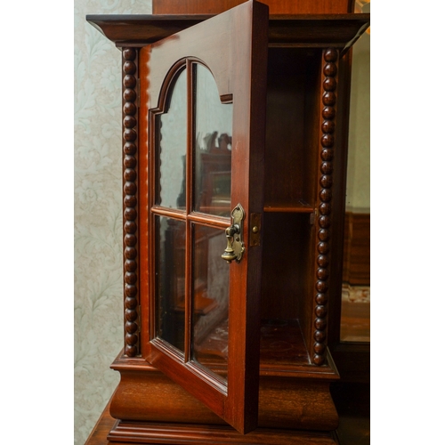 388 - A 1920's mirror back sideboard, with glazed single door cabinets flanking the mirrored back, the bas... 