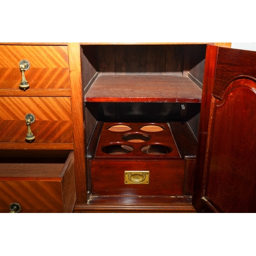 388 - A 1920's mirror back sideboard, with glazed single door cabinets flanking the mirrored back, the bas... 