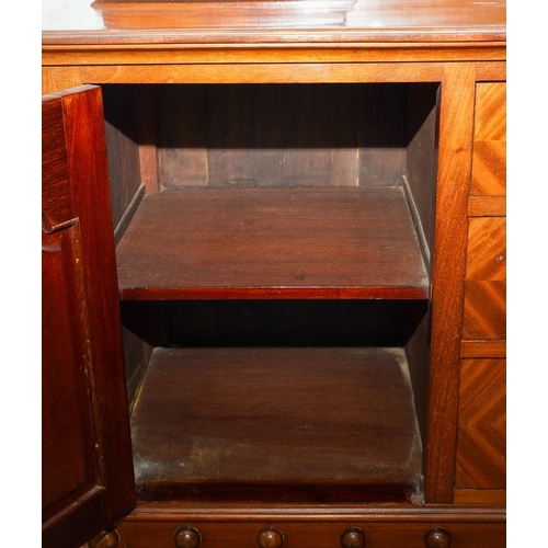 388 - A 1920's mirror back sideboard, with glazed single door cabinets flanking the mirrored back, the bas... 