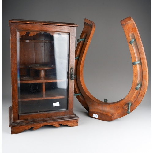 394 - An early 20th Century carved mahogany novelty coat wall rack in the form of a horse shoe with eight ... 