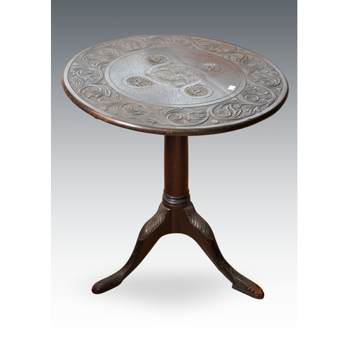 396 - A 19th Century Indian style carved circular tilt top supper table, the central motif within a band o... 