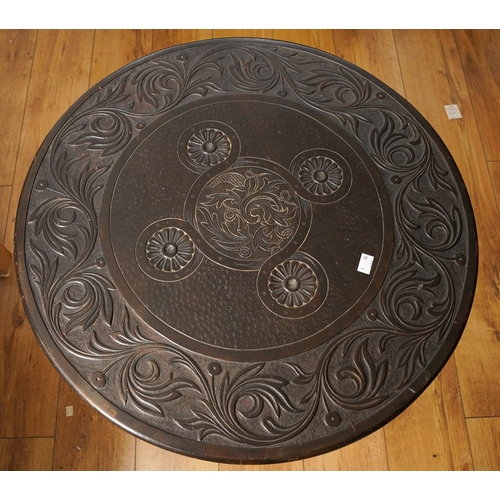 396 - A 19th Century Indian style carved circular tilt top supper table, the central motif within a band o... 