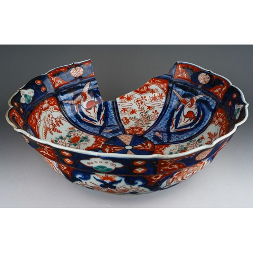 1007 - A 19th century Japanese Imari bowl of panelled circular form, wavy rim, four character mark to under... 