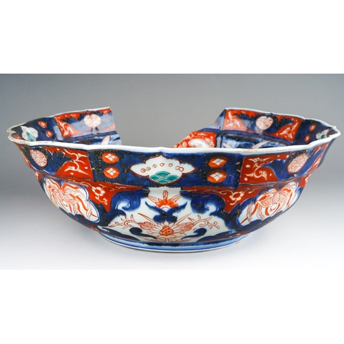 1007 - A 19th century Japanese Imari bowl of panelled circular form, wavy rim, four character mark to under... 