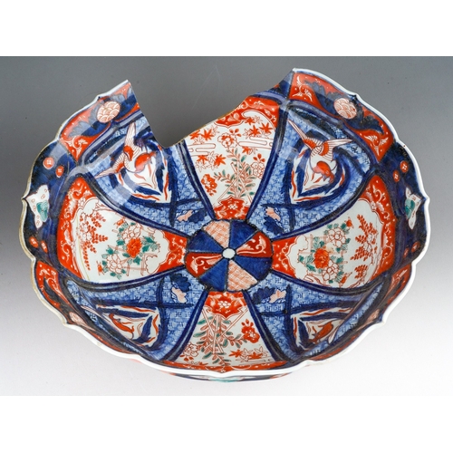 1007 - A 19th century Japanese Imari bowl of panelled circular form, wavy rim, four character mark to under... 