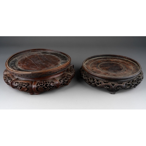 1011 - Two Chinese carved hardwood bowl stands, some splits, approx 27cm and 23cm at widest points [2]