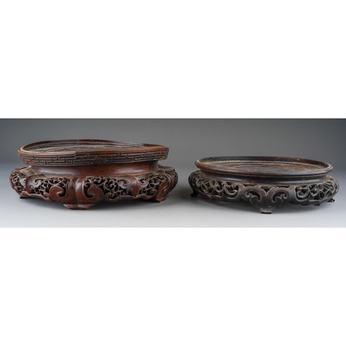 1011 - Two Chinese carved hardwood bowl stands, some splits, approx 27cm and 23cm at widest points [2]