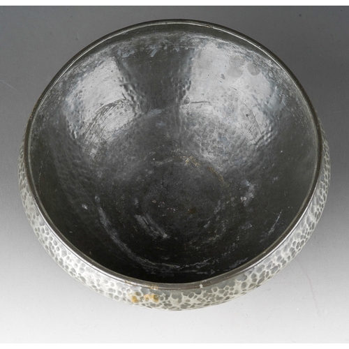 1029 - A Liberty & Co English Pewter (Tudric) hammered bowl on three supports, stamped 01128, the aperture ... 