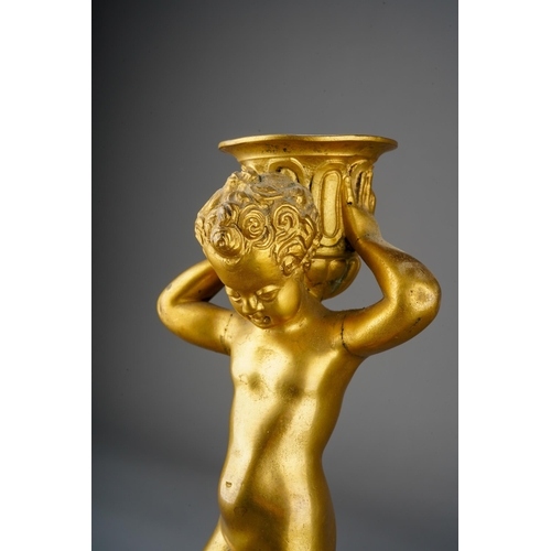 1030 - A 18th Century style French gilt metal candlestick, modelled as a putto holding scone aloft on tripo... 