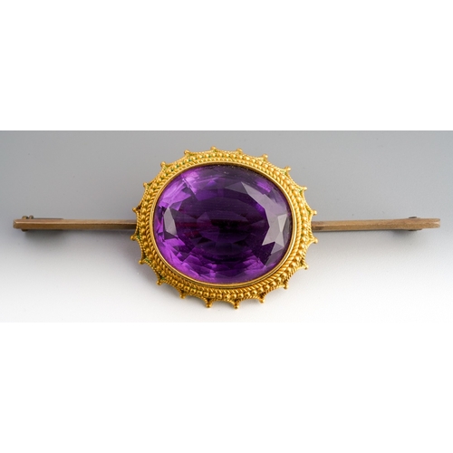 679 - An early 20th century amethyst bar brooch, unmarked, approx length 75mms, gross weight 19.16 grams.