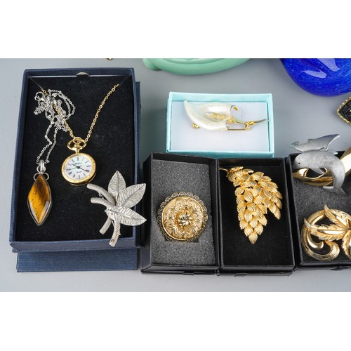 675 - Collection of costume jewellery to include brooches and 4 glass panels together with a blue glass Co... 