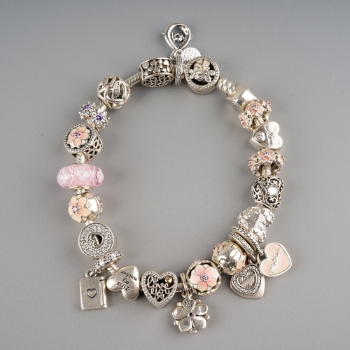 676 - Pandora style charm bracelet with approx. 21 charms on it