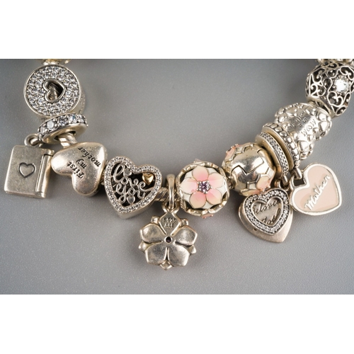 676 - Pandora style charm bracelet with approx. 21 charms on it