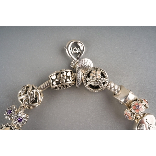 676 - Pandora style charm bracelet with approx. 21 charms on it