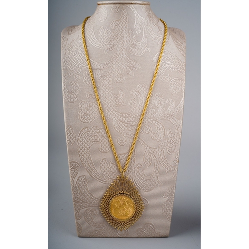 726 - 1908 full Sovereign in large 9 ct gold mount on a yellow metal chain, total gross weight approx. 21.... 