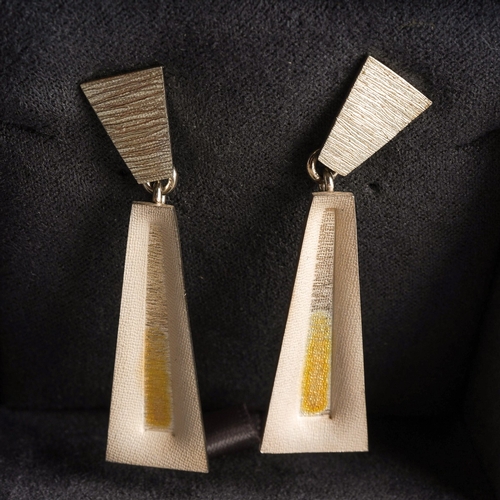 841 - A pair of yellow and white metal earrings. Stamped 925, fixed posts for pierced ears, with Steenson ... 