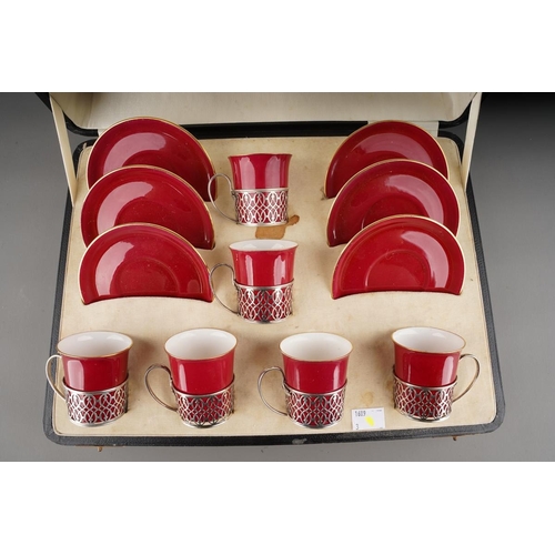 6 - A Cased Set of Six George V Silver-Mounted Coffee-Cups and Saucers, Pierced Silver Mounts ,The Porce... 