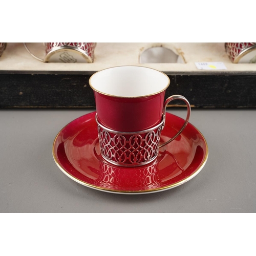 6 - A Cased Set of Six George V Silver-Mounted Coffee-Cups and Saucers, Pierced Silver Mounts ,The Porce... 