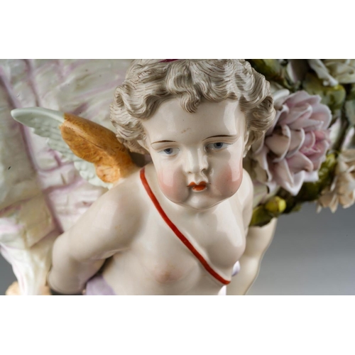 10 - A Sitzendorf large figural table centrepiece modelled a conch shell applied with flowers and foliage... 