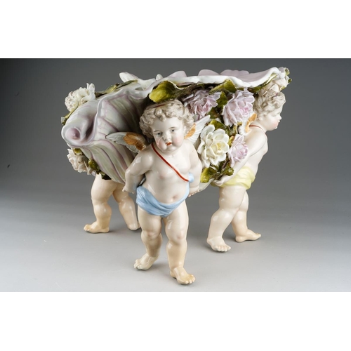 10 - A Sitzendorf large figural table centrepiece modelled a conch shell applied with flowers and foliage... 