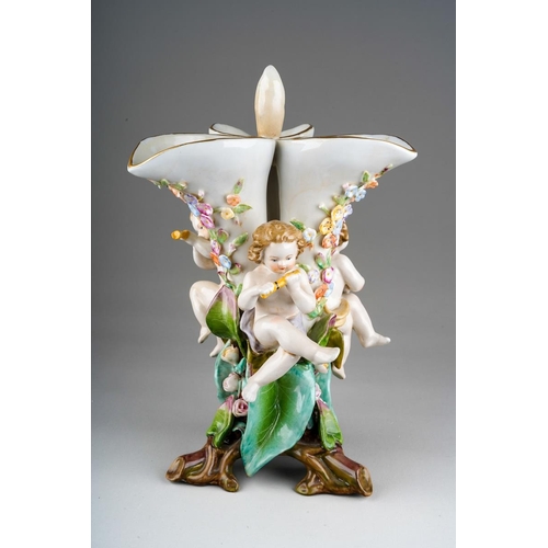 10 - A Sitzendorf large figural table centrepiece modelled a conch shell applied with flowers and foliage... 