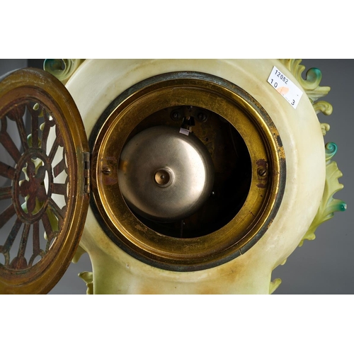 11 - A Continental porcelain Rococo style mantle clock., the apple green and gilt scrolling case applied ... 