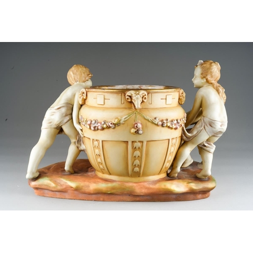 12 - An early 20th Century Amphora porcelain blush ivory large figural jardiniere modelled as three child... 