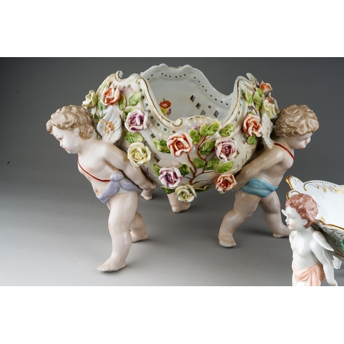 13 - A German porcelain large fruit bowl, the shaped bowl with diamond lozenge piercing applied with rose... 